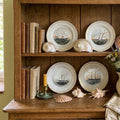 Set of nautical display plates arranged on wall as collected coastal grouping