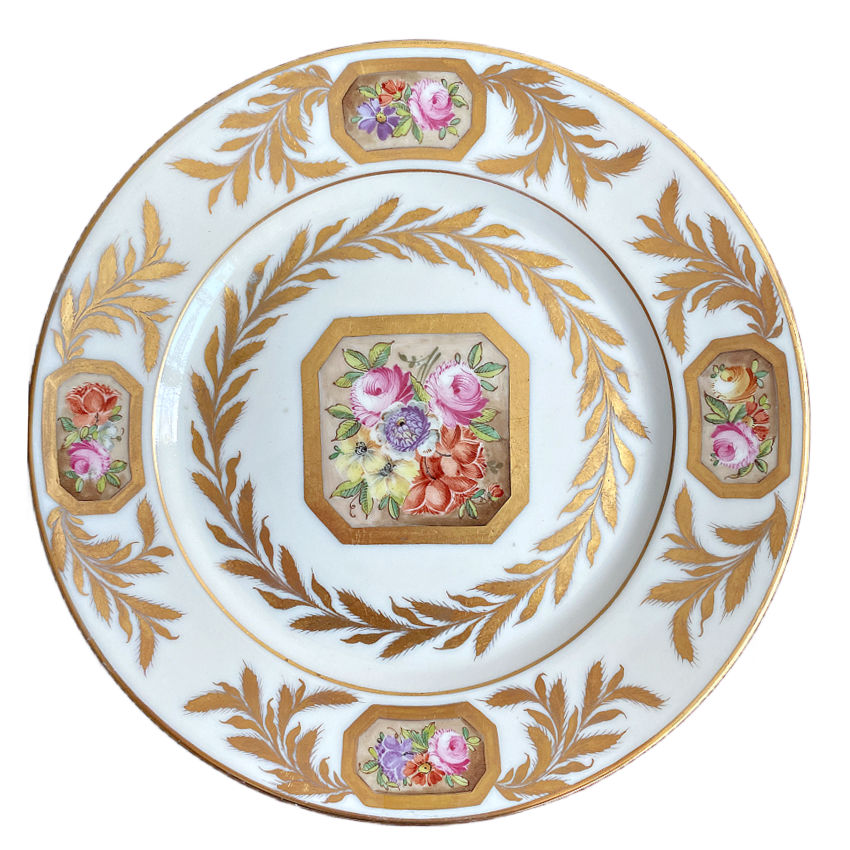 Close up French porcelain plate by Porcelaine de Paris featuring hand painted garden florals and gilt border