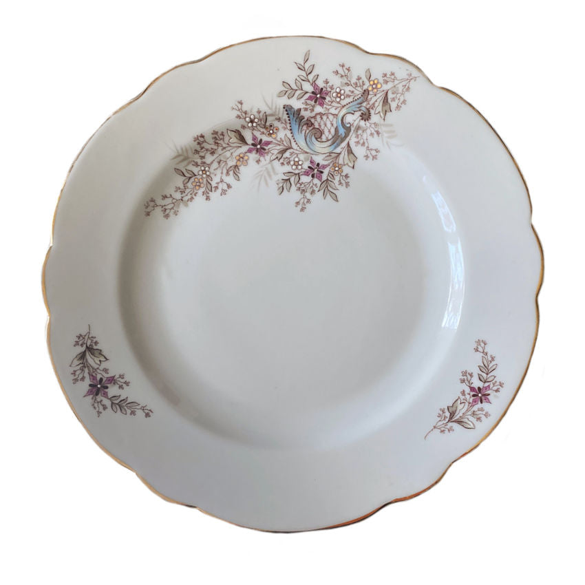 antique French porcelain plates with raised enamel details and gilded scalloped rims detail