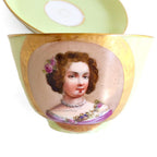 lose up of a Antique French Sevres Vieux Paris porcelain tea cup and saucer in rare apple green, hand-painted with delicate female portrait and gilt accents. The portair features a woman with pearls, pinnk rose in her hair, and jewels and roses on her pink gown.