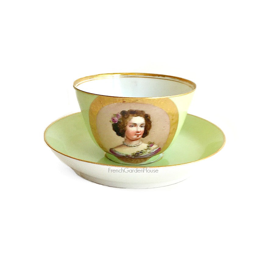 Antique French Sevres Vieux Paris porcelain tea cup and saucer in rare apple green, hand-painted with delicate female portrait and gilt accents. A charming collectible from a European estate, perfect for antique French porcelain enthusiasts- girl with curly hair and a pink rose.