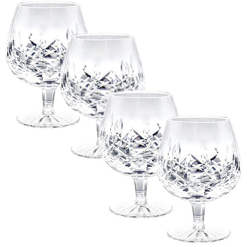 A refined set of four signed Waterford Lismore crystal brandy glasses, beautifully preserved with brilliant diamond and wedge cuts. Timeless Irish craftsmanship for elegant entertaining.