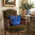 Southern Blue jacquard designer handbag on olive green velvet French bergère chair