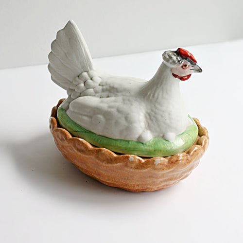 Side view of 19th century Staffordshire hen on nest tureen showing hand painted details and glazed basket base.
