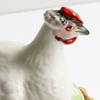 Side view of hand-painted hen lid on antique 19th century Staffordshire Hen on Nest Tureen, showcasing profile, beak, and intricate detail.