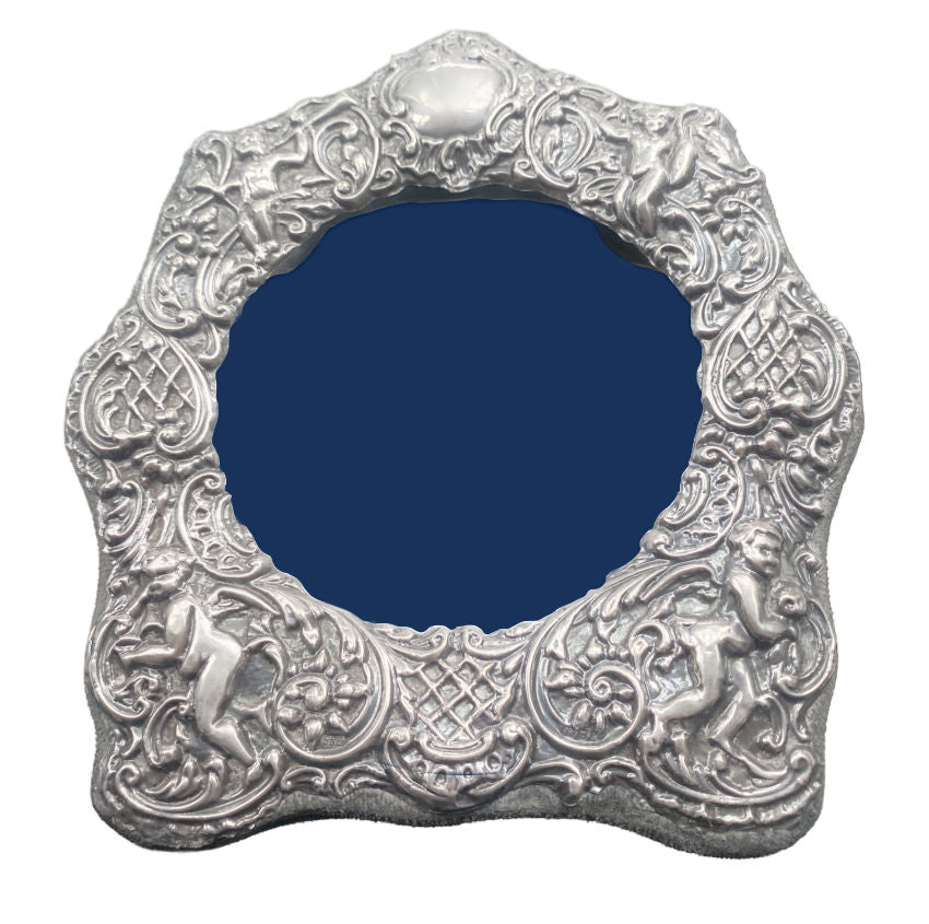 

Antique sterling silver photo frame with repoussé cherubs and putti floral scrollwork