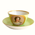 Antique French Sevres Vieux Paris porcelain tea cup and saucer in rare apple green , hand-painted with a delicate female portrait and gilt accents. A charming collectible from a European estate, perfect for antique French porcelain enthusiasts.