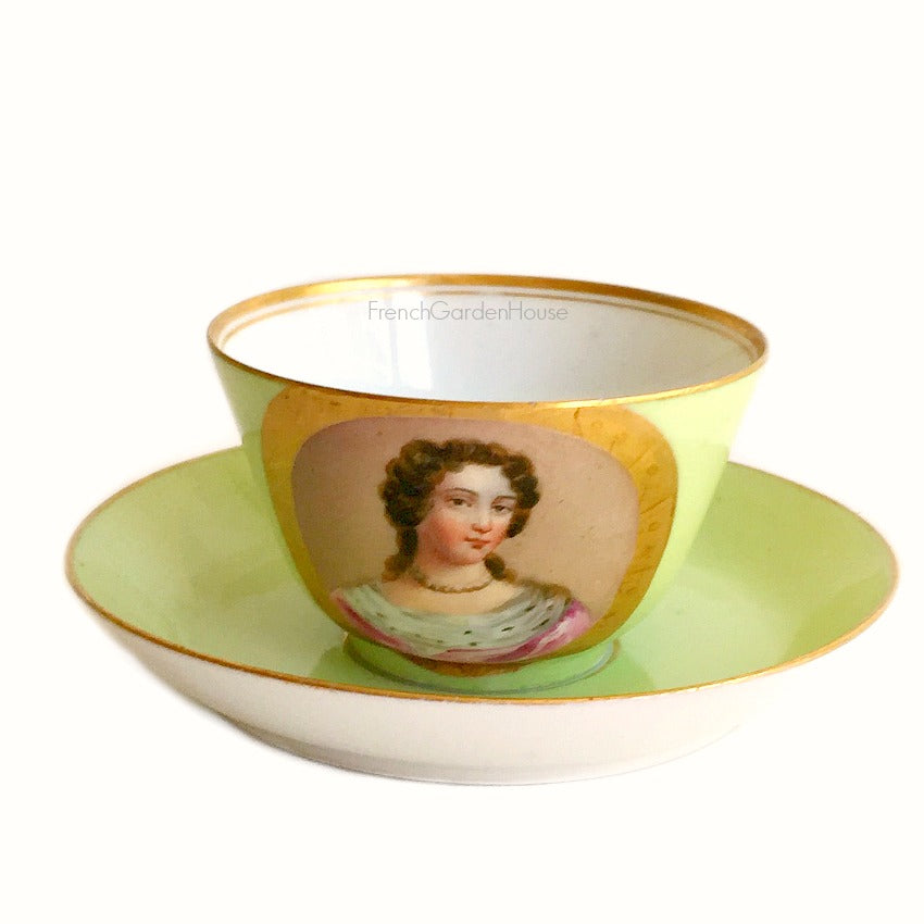 Antique French Sevres Vieux Paris porcelain tea cup and saucer in rare apple green , hand-painted with a delicate female portrait and gilt accents. A charming collectible from a European estate, perfect for antique French porcelain enthusiasts.