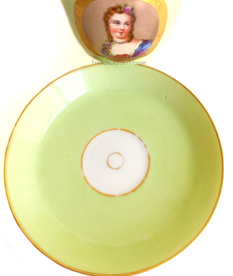 Antique French Sevres Vieux Paris porcelain tea saucer in rare apple green, hand-painted with delicate female portrait and gilt accents. 
