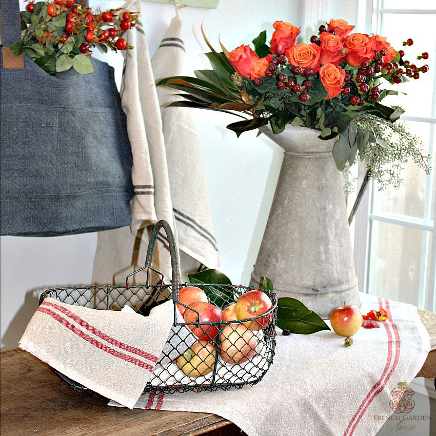 French red Striped towel in kitchen with roses and French country basket with red apples