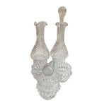 Set of clear glass decanters on a white background