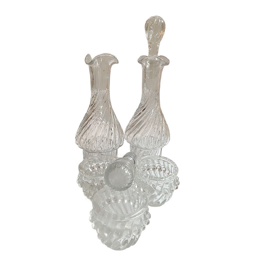 Set of clear glass decanters on a white background