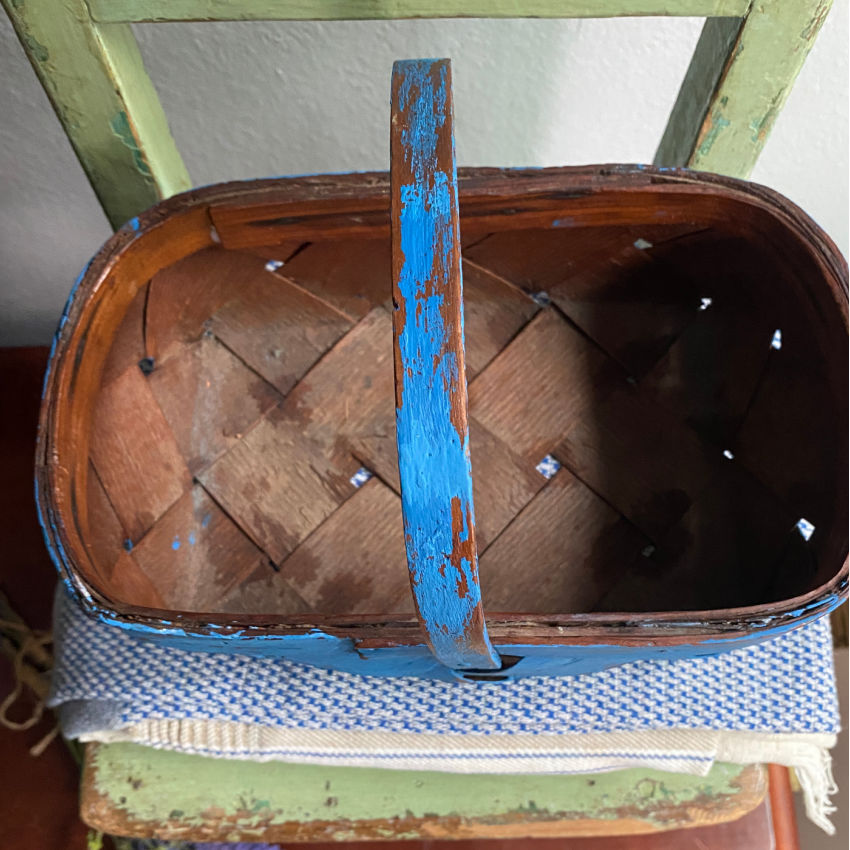 Top view of a vintage French splint wood basket showing hand-woven interior and sturdy handle.