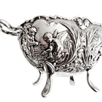 Close-up of cherub and floral relief on vintage silver plated bowl