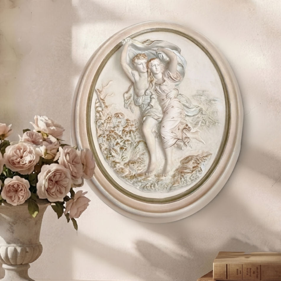 Oval chalkware sculpture with romantic couple scene and soft pastel colors with gilt accents with french pink roses