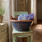 Vintage blue painted basket holding towels and lavender in a French Country kitchen