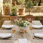 Vintage delicate etched glass stemware set on an outdoor table set for lunch in a French garden 