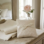 Antique cream French lavender sachet on bedside table