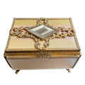 Decorative antique French ormolu jewelry box with gold embellishments and pink silk