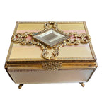 Decorative antique French ormolu jewelry box with gold embellishments and pink silk