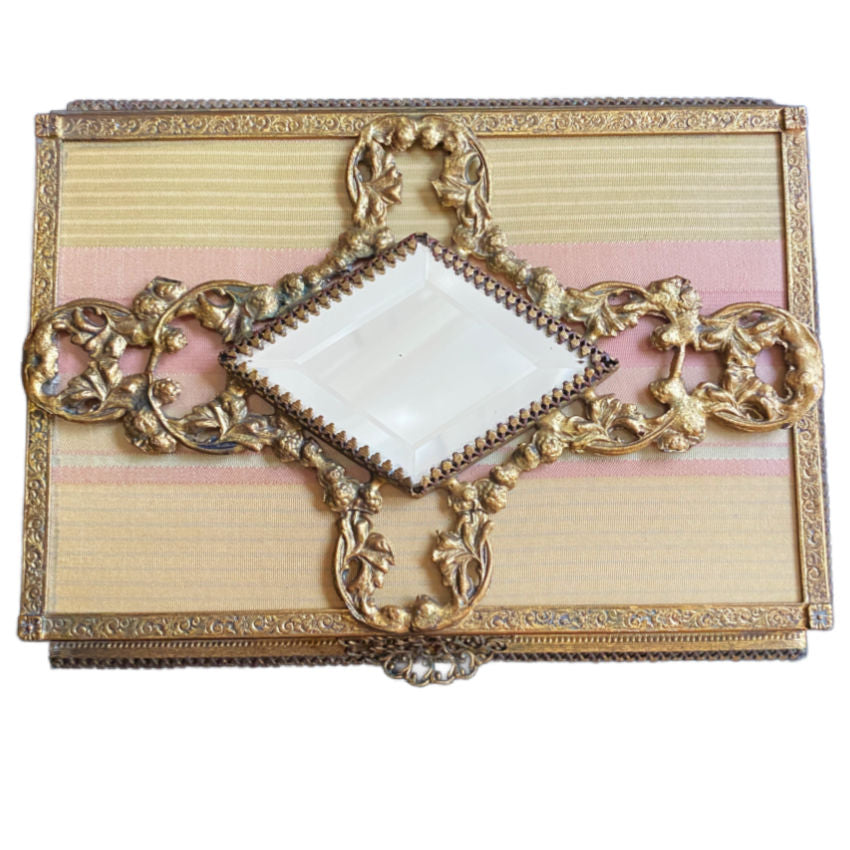 Anrtique French Decorative jewel casket  box with gold embellishments and a central diamond-shaped panel on a striped pink silk background