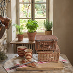 Vintage French basket styled with bread and linens in a French Country kitchen