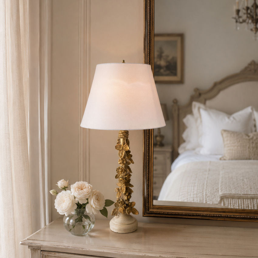 Vintage gold rose column lamp on a French country bedroom dresser