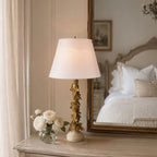 Vintage gold rose column lamp on a French country bedroom dresser