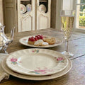 Set vintage Spode Dubarry plates tablescape styling English transferware styled on atable for lady's tea with champagne and French tarts.