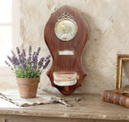 Wall-mounted French devotional font from Notre Dame de Lourdes, Paris souvenir with gilt and silver details on a french country commode with a lavender plant and crucifix