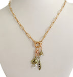 Layered jewelry look with cast bronze vine charm and freshwater pearls, romantic botanical collectible design
