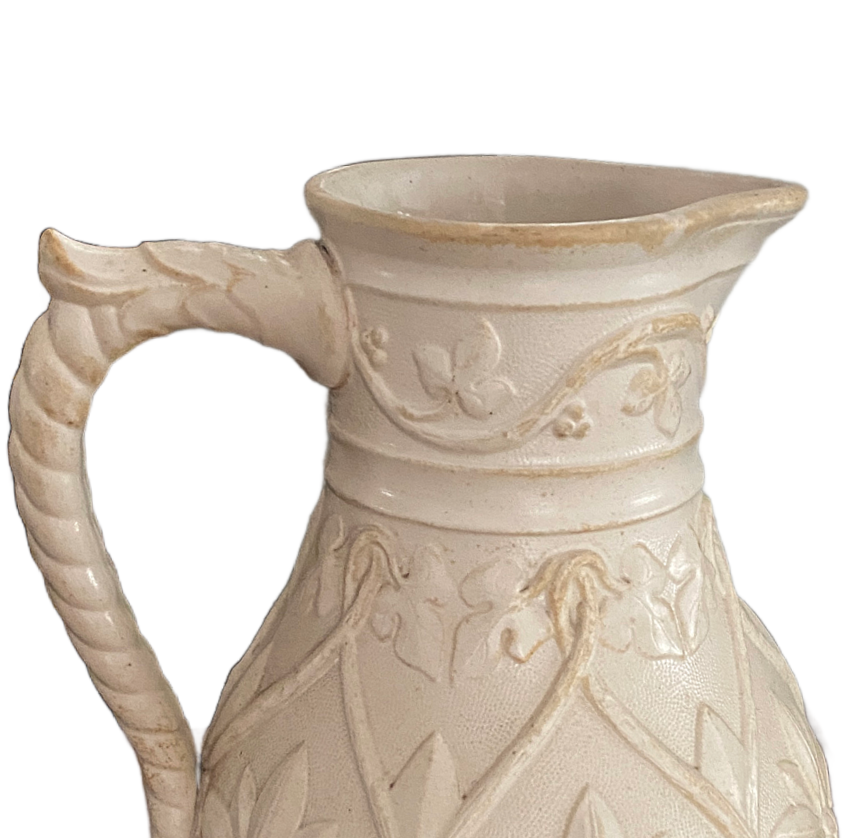 Victorian English stoneware pitcher sculptural floral relief design aged patina on rim.