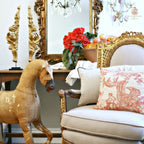 Elegant château inspired interior with French gilt gesso angel fragments and flowers