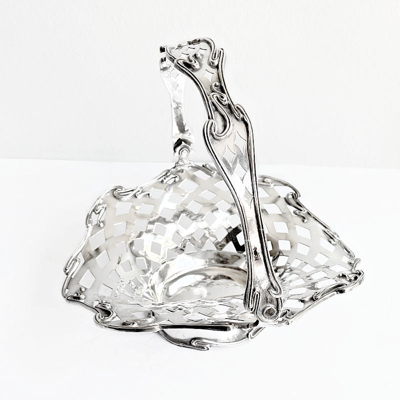 Close view Meriden silver plate basket lattice detail and curved organic handle