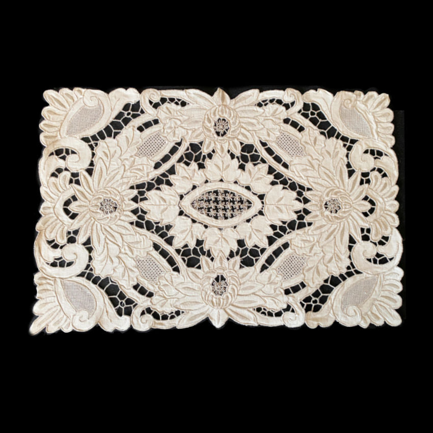 Close view of intricate hand embroidered Madeira floral linen detail