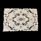 Close view of intricate hand embroidered Madeira floral linen detail