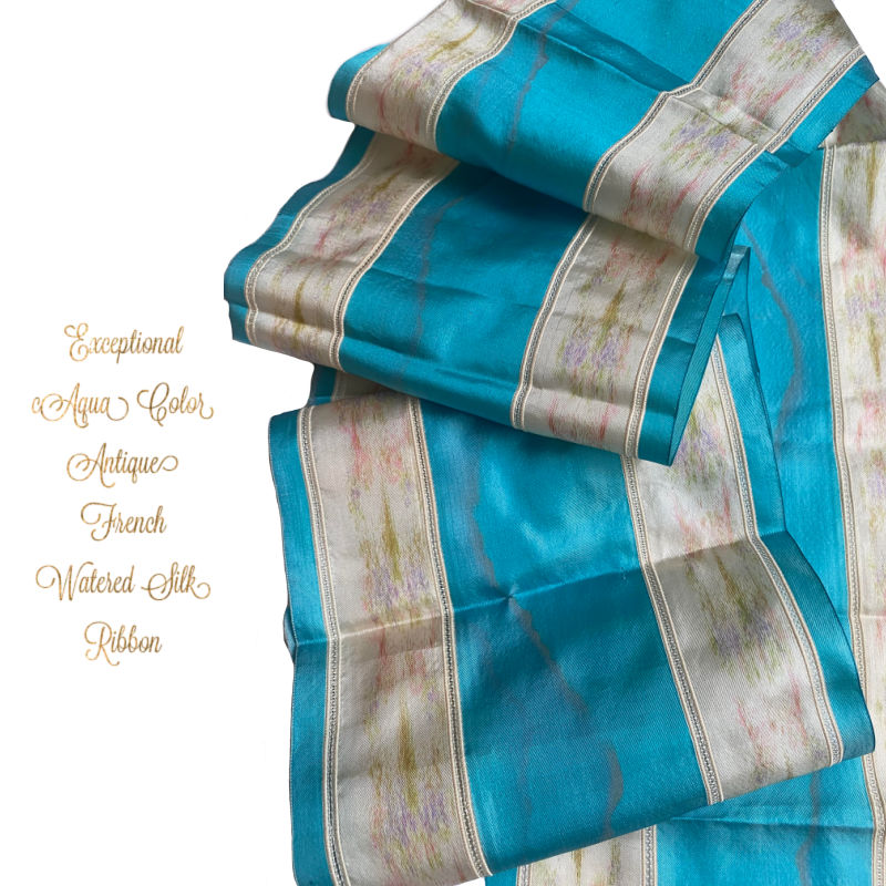 Antique French watered silk ribbon, of aqua blue and white striped silk ribbon with floral patterns in pink, lavender, and green.