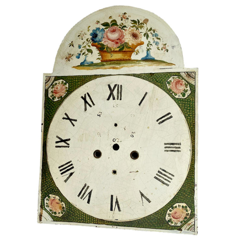 Antique hand painted large floral basket clock face with a visible patina and floral motifs around the edge.