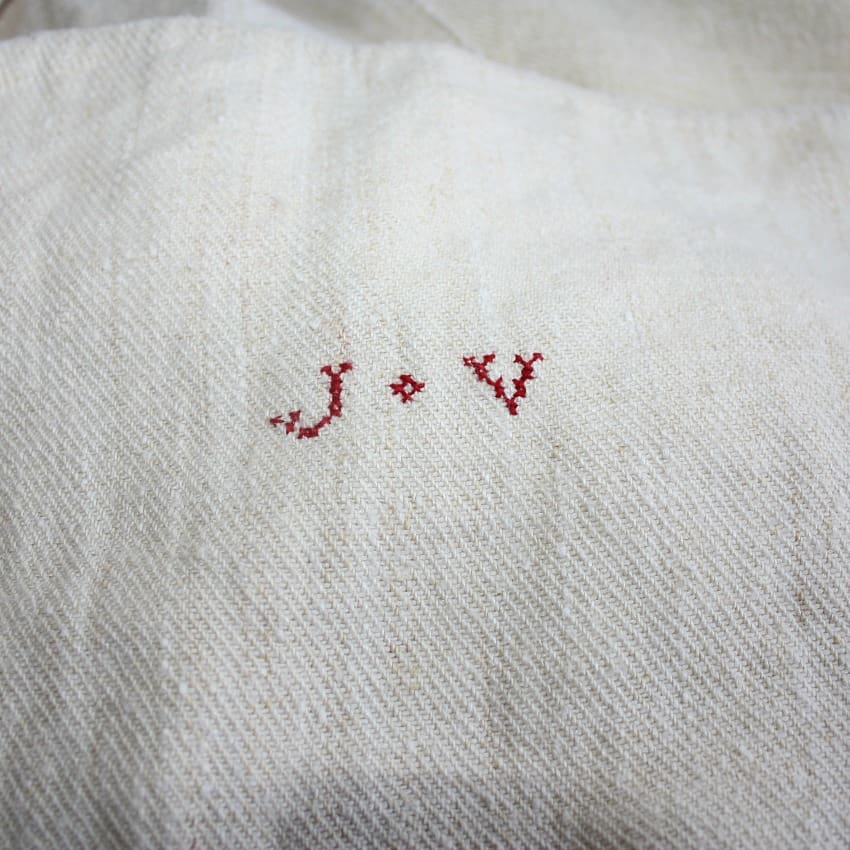 Original J.V. embroidered family laundry monogram on antique French linen tablecloth