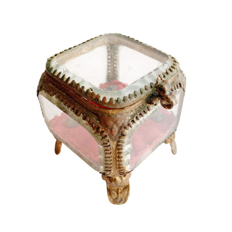 Antique French Gilt Ormolu Jewelry Casket with beveled glass top and a red cushion with blue enamel buttons.