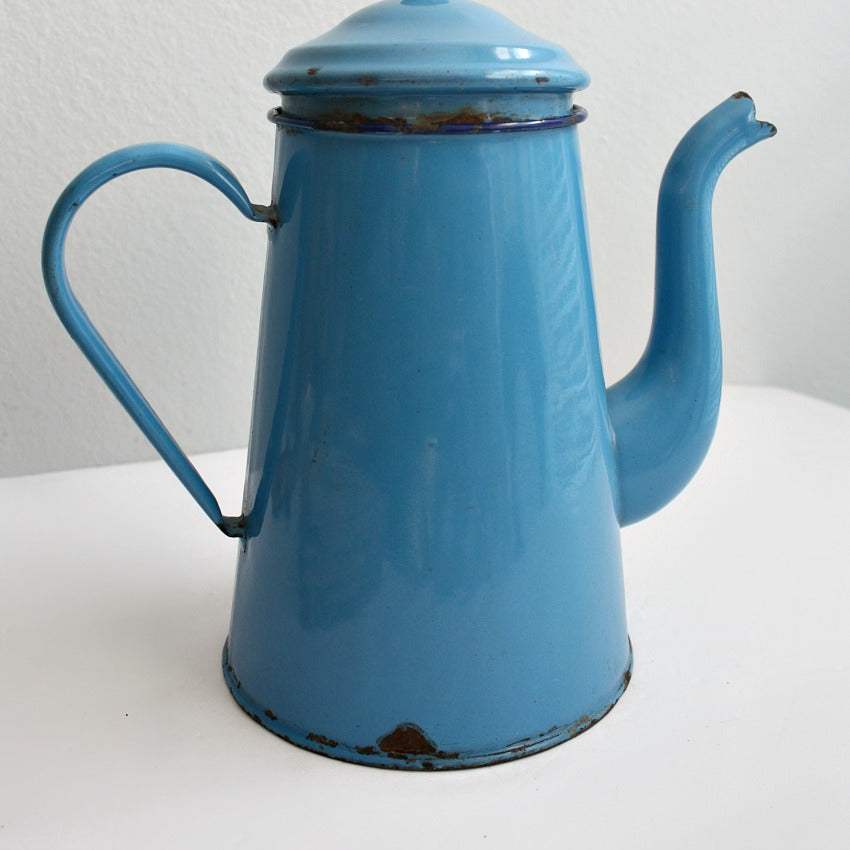 Close up of vintage French cafetière in blue enamel with authentic aged finish