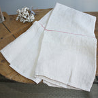 Close up of antique French linen weave and hand stitched hem