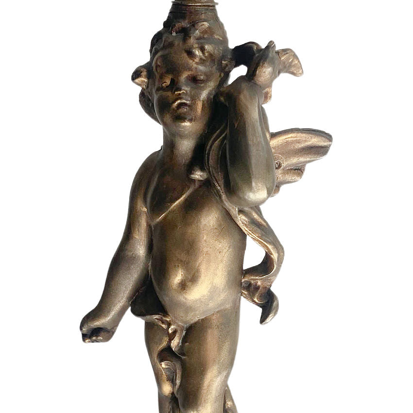close-up of vintage metal gilt cherub lamp