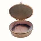 Inside of Antique french souvenir gilded pink lined casket with feathers