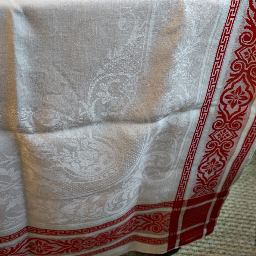 Close detail of French damask linen weave and floral border