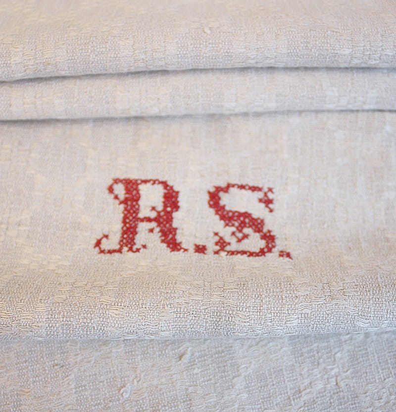 Hand embroidered French Country linen towel close up of monogram in red