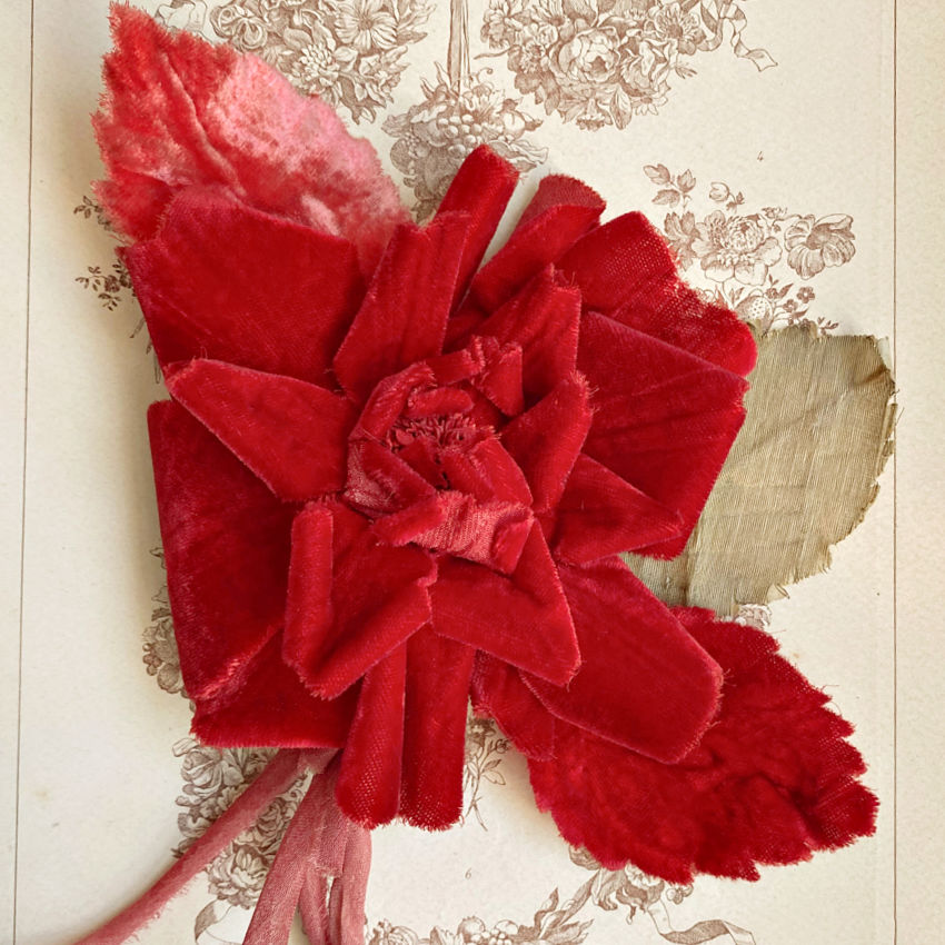 Antique millinery red silk velvet rose with richly sculpted petals. A couture velvet flower once adorning a fine hat or gown, romantic and beautifully preserved.