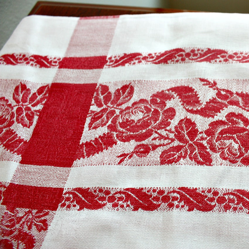 Antique French heirloom rose damask linen tablecloth displaying classic woven floral design and crisp white linen