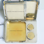 Gilt interior antique minaudière showing card and coin sections