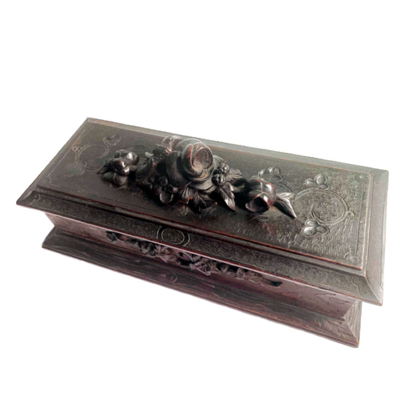 Antique French Black Forest hand-carved wooden jewelry or glove box with a floral top and a key hole on the front.